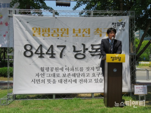 김윤기 정의당 대전시당위원장이 13일 대전시청 북문 앞에서 월평공원 아파트 건설을 반대하는 8,447명의 서명부를 읽는 '8447 낭독회'를 진행하고 있다. / © 뉴스티앤티