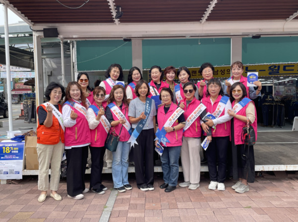 아산시여성단체협의회는 지난 2일 추석 명절을 맞아 온양온천시장에서 전통시장 장보기 행사를 진행한 가운데, 고삼숙 회장과 김정자 아산시 여성복지과장을 비롯한 참석자들이 손 하트 포즈를 취하며 기념촬영을 하고 있다. / 아산시청 제공