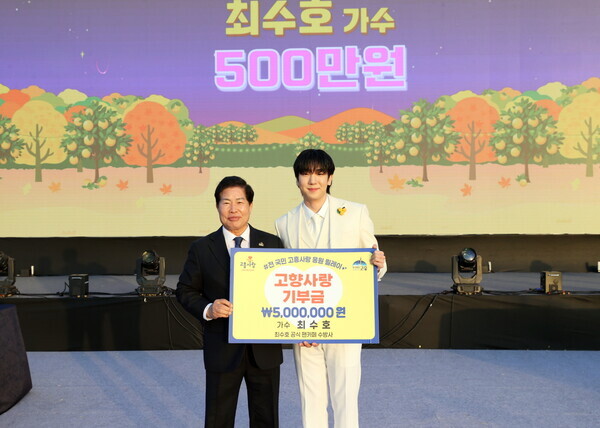 고흥군 유자축제장에서 트로트 가수 최수호 씨가 고향사랑기부제에 동참하고 공영민 고흥군수와 기념촬영을 하고 있다./고흥군 제공